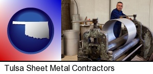 Tulsa, Oklahoma - a sheet metal worker fabricating a metal tube
