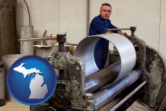 michigan map icon and a sheet metal worker fabricating a metal tube