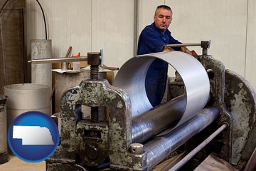 a sheet metal worker fabricating a metal tube - with Nebraska icon